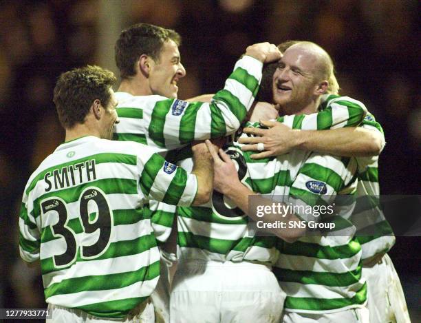 Celtic players crowd Alan Thompson after his goal