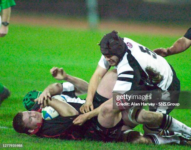 Allan Jacobsen of Edinburgh and Tom Palmer fight for ball