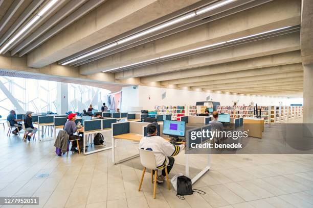 people inside public library building downtown calgary alberta canada - downtown calgary stock pictures, royalty-free photos & images