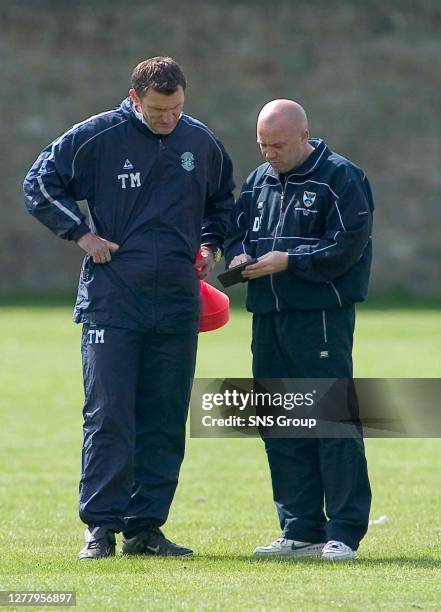 Manager Tony Mowbray and Fitness coach Dougie Fowler run the rule over the Hibs squad