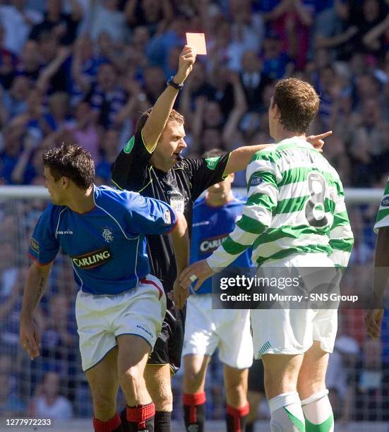 Celtic midfielder Alan Thompson is ordered from the field by referee Stuart Dougal after a cynical foul on Rangers striker Nacho Novo.