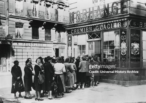 Queue of women outside a dairy shop, in German-occupied Paris, 28 June 1940. Shortages and rationing were part of everyday life for Parisians during...