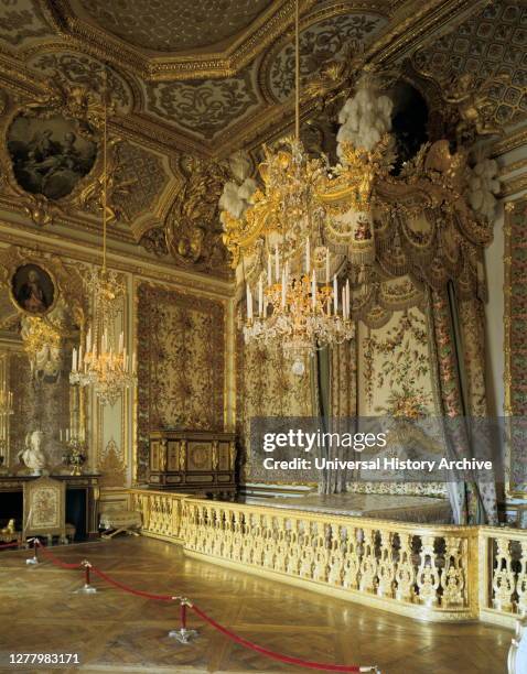 The Queen's Bedchamber, The Queen's Suite , Chateau de Versailles, France. The Rococo-style woodwork, as well as the ceiling painting by Francois...