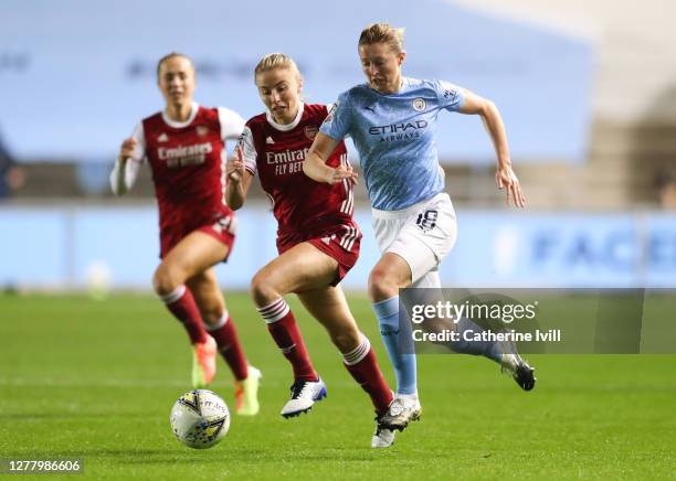 Ellen White of Manchester City is challenged by Leah Williamson of Arsenal during the Vitality Women's FA Cup Semi Final match between Manchester...