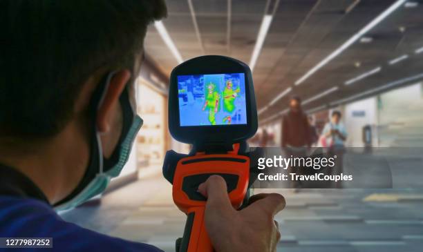 international passengers infrared thermal scan imaging camera on immigration and entry after landing. conceptual security and medical health diagnosis quarantine precaution measurin - thermal imaging stock pictures, royalty-free photos & images