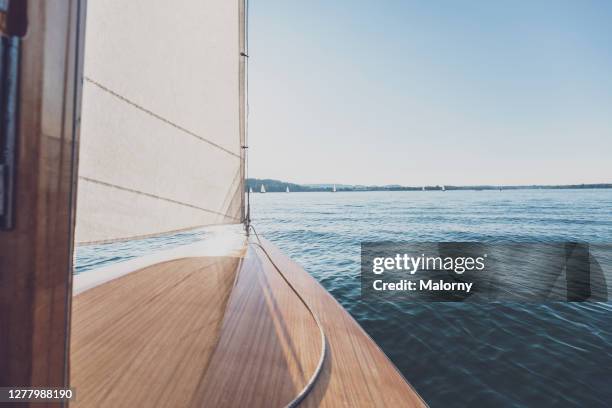personal perspective: white sail or jib, sailboat and lake. - albero maestro foto e immagini stock