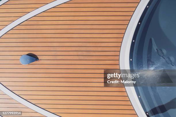 close-up of wooden boat deck. directly above. personal view. - deck stock-fotos und bilder