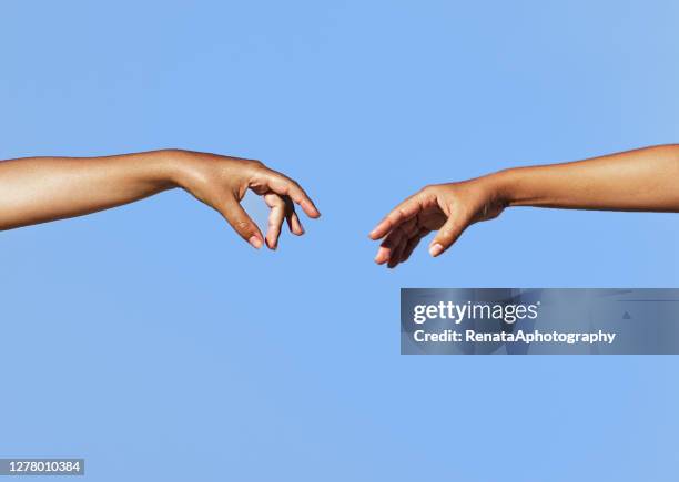 two women's arms outstretched reaching toward each other - woman arms outstretched stock pictures, royalty-free photos & images