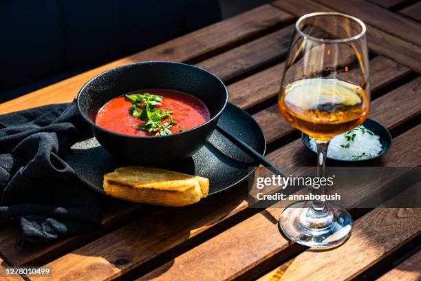 gazpacho soup with a slice of toast and a glass of rose wine - gazpacho stock-fotos und bilder