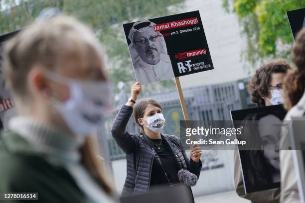 Protesters from Reporters Without Borders, including one holding a sign showing murdered Saudi Arabian journalist Jamal Khashoggi, demonstrate...