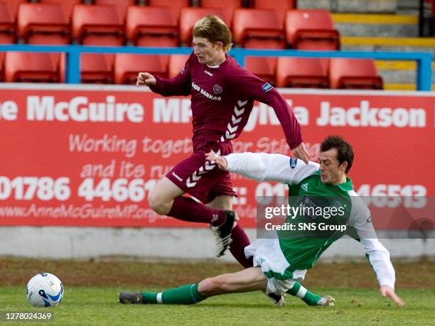 Jason Thomson skips over a tackle from Hibs' Stephen Fletcher