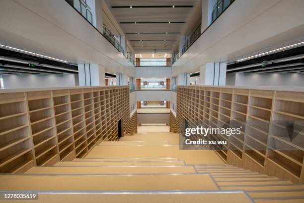 empty bookcase by the stairs - trapezoid stock pictures, royalty-free photos & images