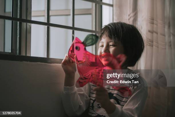 asian chinese young girl drawing on the rabbit shape chinese lantern preparing for mid autumn festival at night - porcelain stock pictures, royalty-free photos & images