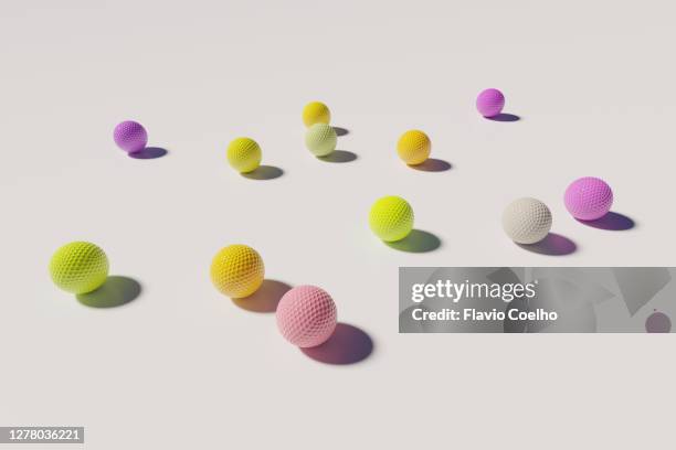 colorful golf balls on white background - drive ball sports stock pictures, royalty-free photos & images