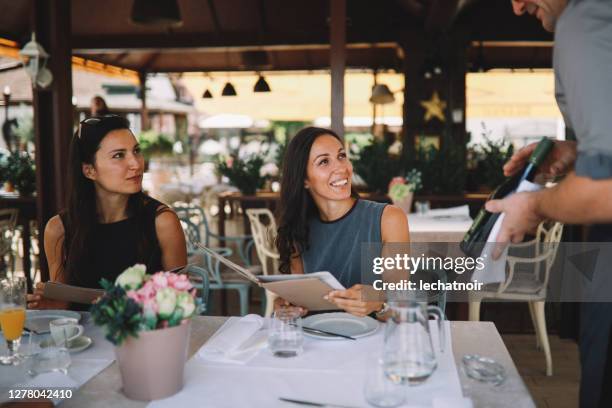 female friends ordering food in the restaurant - restaurant women friends lunch stock pictures, royalty-free photos & images