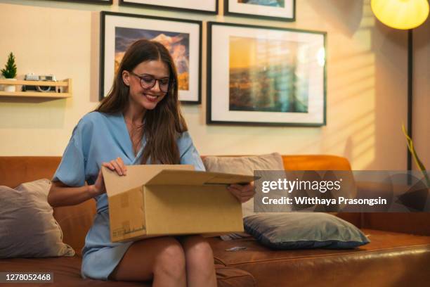 woman getting a package on the mail - care package stock pictures, royalty-free photos & images