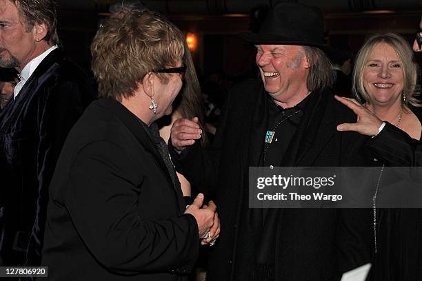 Presenters Elton John, Neil Young and Pegi Young attend a dinner for the 26th annual Rock and Roll Hall of Fame Induction Ceremony at The...