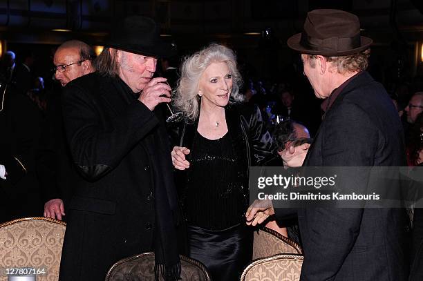 Presenter Neil Young, singer Judy Collins and inductee Tom Waits attends a dinner for the 26th annual Rock and Roll Hall of Fame Induction Ceremony...
