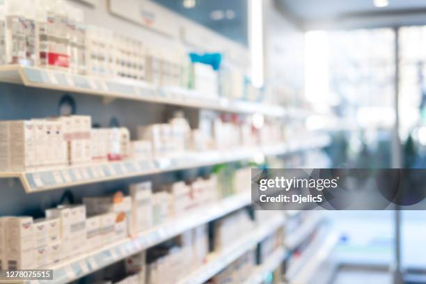 blurred pharmacy background. - empty super market shelf stock pictures, royalty-free photos & images