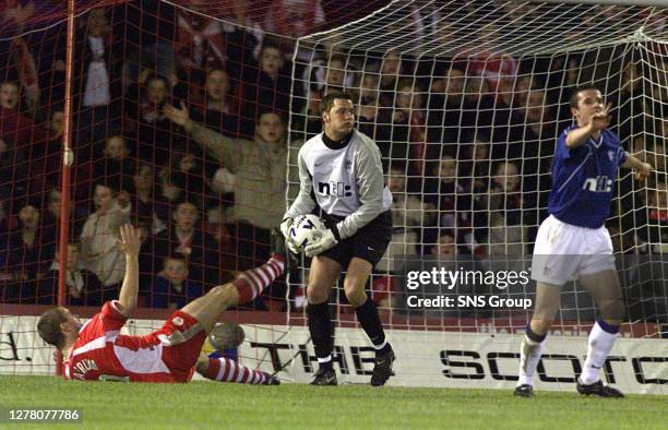 Rangers goalkeeper Jesper Christiansen collects the ball as Barry Ferguson pleads his innocence after clattering into Aberdeen's Arild Stavrum.