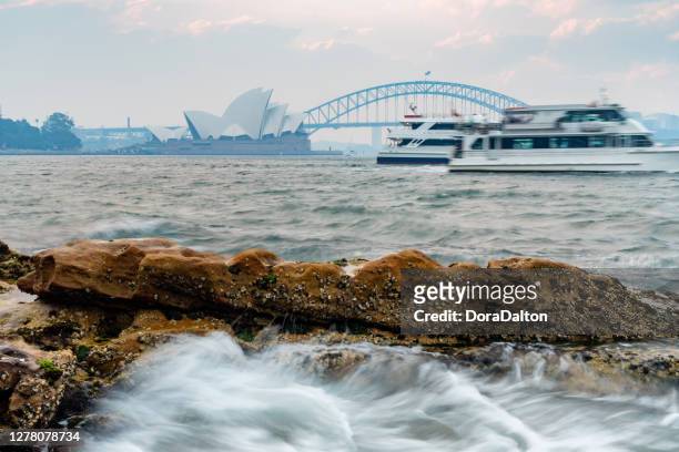 sydney harbour bridge and sydney opera house obscured by smoke from various bushfires across nsw, australia - sydney smoke stock pictures, royalty-free photos & images