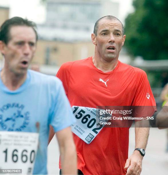 Rangers manager Paul Le Guen joins other exhausted competitors as he crosses the finish line of the Great Scottish Run