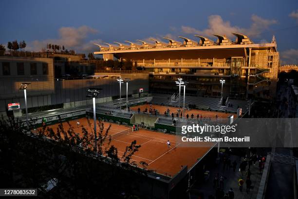 General view of Court 9 with Court Philippe-Chatrier in the background as the sun sets on day six of the 2020 French Open at Roland Garros on October...