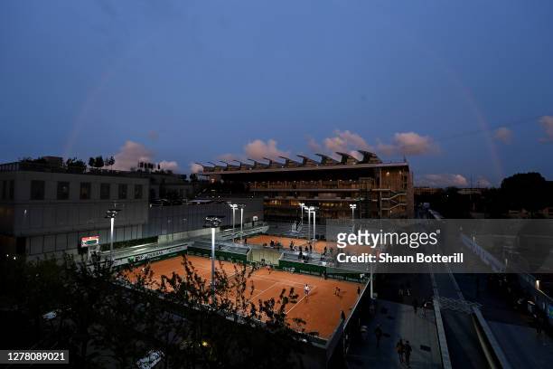 General view of Court 9 with Court Philippe-Chatrier in the background as the sun sets on day six of the 2020 French Open at Roland Garros on October...