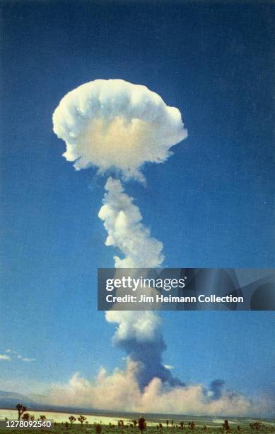 Photographic postcard shows a mushroom cloud explosion against a blue sky, circa 1952.