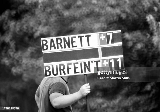 Volunteer scorer holds a scoreboard showing Pam Barnett at plus 7 and Betty Burfeindt at plus 11 during the 1972 U.S. Women's Open Golf Championship...