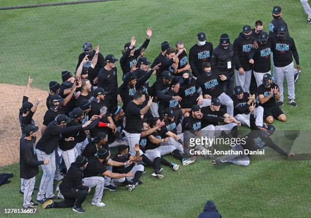 Members of the Miami Marlins celebrate a win over the Chicago Cubs during Game Two of the National League Wild Card Series at Wrigley Field on...