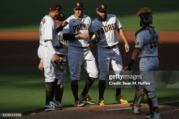 Manny Machado, Eric Hosmer, and Austin Nola congratulate Craig Stammen of the San Diego Padres after being pulled during the second inning of Game...