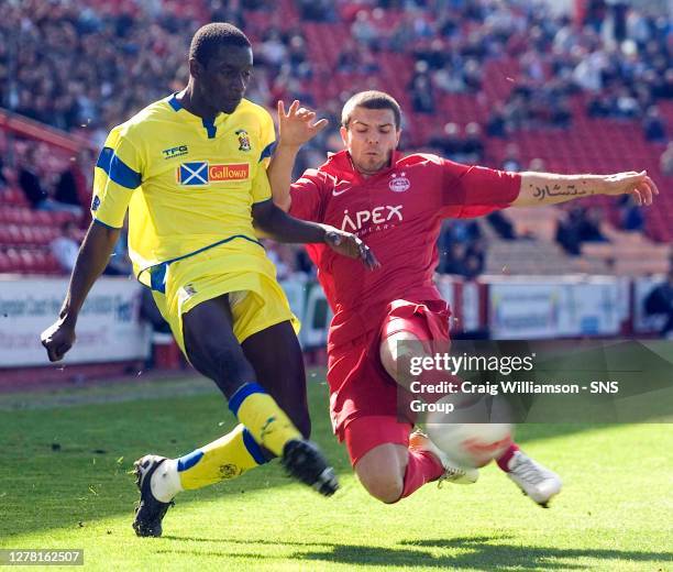 Richard Foster challenges Kilmarnock's Momo Sylla