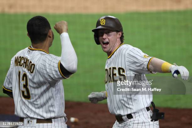 Jake Cronenworth of the San Diego Padres celebrates a solo home run with Manny Machado during the eighth inning of Game Three of the National League...