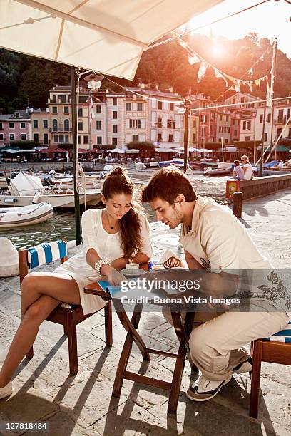 young couple on vacation in portofino - couple in cafe coffee stock pictures, royalty-free photos & images