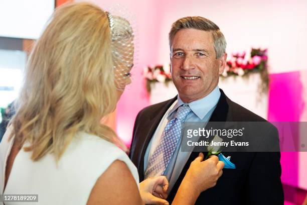Samantha Armytage pins a rose to the jacket of Richard Lavender are seen at The Everest Carnival Fashion Lunch during Epsom Day at Royal Randwick...