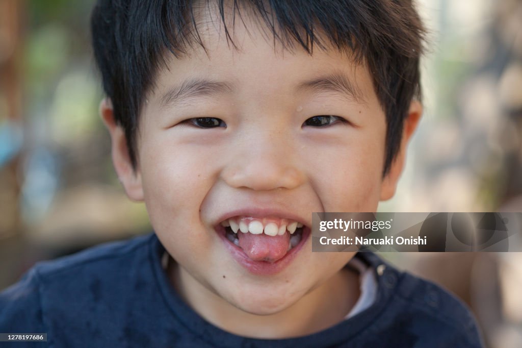 A young child staring at the camera with a smile
