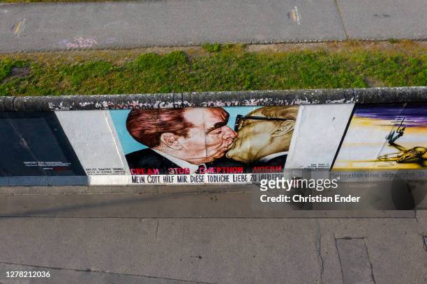 Mural showing Soviet leader Leonid Brezhnev kissing East German President Erich Honecker at the East Side Gallery, a section of the former Berlin...