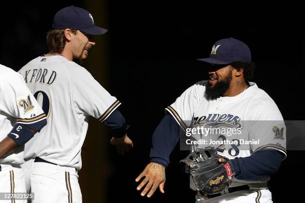 John Axford of the Milwaukee Brewers and Prince Fielder celebrate after their 4-1 win over the Arizona Diamondbacks in Game One of the National...