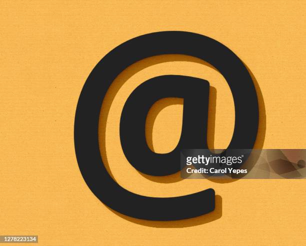 at email sign in black felt and orange background - at symbol fotografías e imágenes de stock