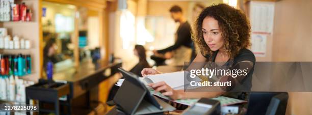 salon owner with touchscreen - online bank account stock pictures, royalty-free photos & images