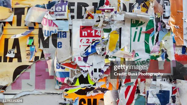 scratched layers of posters and placards on a street wall - word meaning stock pictures, royalty-free photos & images