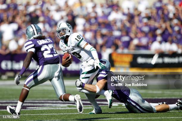 Robert Griffin III of the Baylor Bears gets sacked by Jordan Voelker of the Kansas State Wildcats during the first half of their game at Bill Snyder...