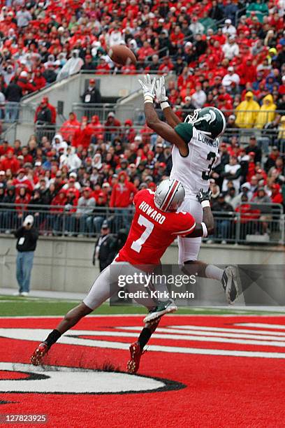 Cunningham of the Michigan State Spartans jumps up and catches a pass for a touchdown while being covered by Travis Howard of the Ohio State Buckeyes...