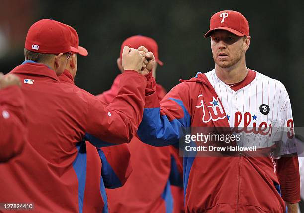 Roy Halladay of the Philadelphia Phillies is greeted by teammates during introductions prior to playing the St. Louis Cardinals in Game One of the...