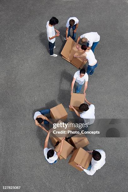 people putting together cardboard boxes - giving back bildbanksfoton och bilder