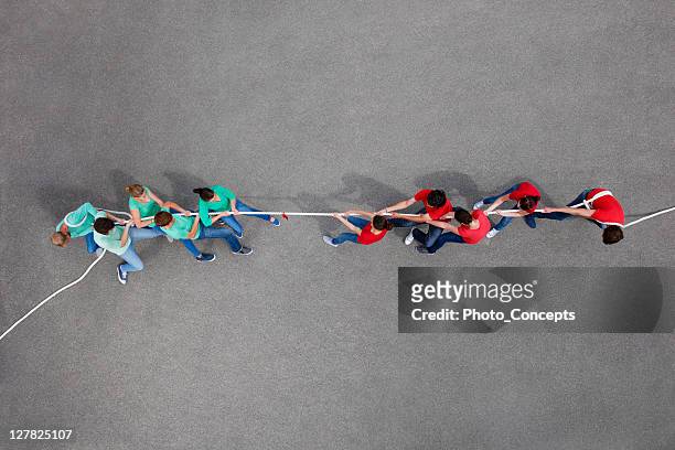 people playing tug of war - collective effort stock pictures, royalty-free photos & images