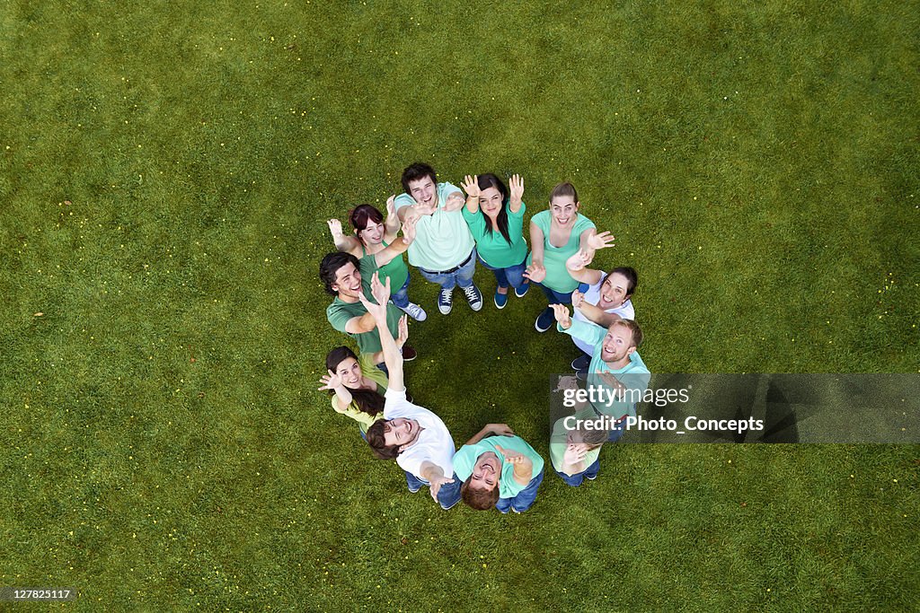 People standing in a circle on grass