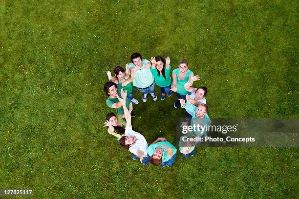 people standing in a circle on grass - people aerial view stockfoto's en -beelden