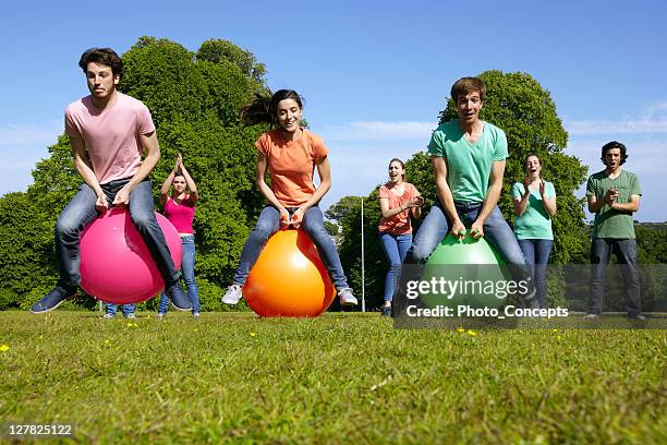 teams racing on exercises balls - outdoor championships stock pictures, royalty-free photos & images